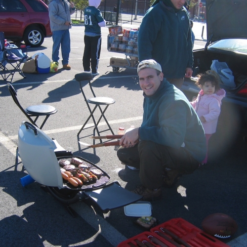 Danny checks the meat with Julia watching over the process