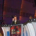 Mel Kiper, Jr. picks his ear or adjusts an ear piece or does something to that magical coif of a hair helmet!