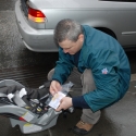 Daddy tries to figure out the car seat