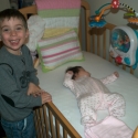 Cousin Max with Sara in her crib