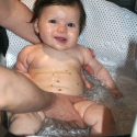 Now too big for her bathtub, Sara enjoys getting clean right in the sink