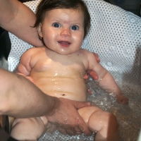 Now too big for her bathtub, Sara enjoys getting clean right in the sink
