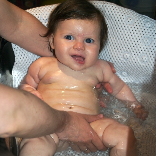 Now too big for her bathtub, Sara enjoys getting clean right in the sink