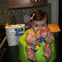 Sitting in her new bumbo seat, watching daddy cook!