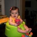 Sitting in her new bumbo seat, watching daddy cook!