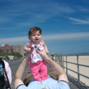 Sara and Daddy playing on the boardwalk in Coney Island