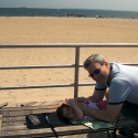 Sara and Daddy playing on the boardwalk in Coney Island