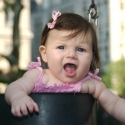 Sara giggles as she swings
