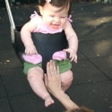 Sara giggles as she swings