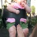 Sara giggles as she swings