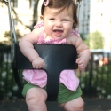 Sara giggles as she swings