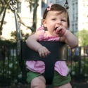 Sara giggles as she swings