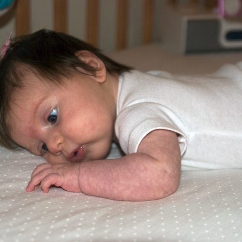 Sara relaxes in her crib