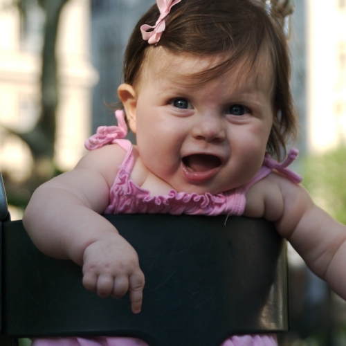 Sara giggles as she swings